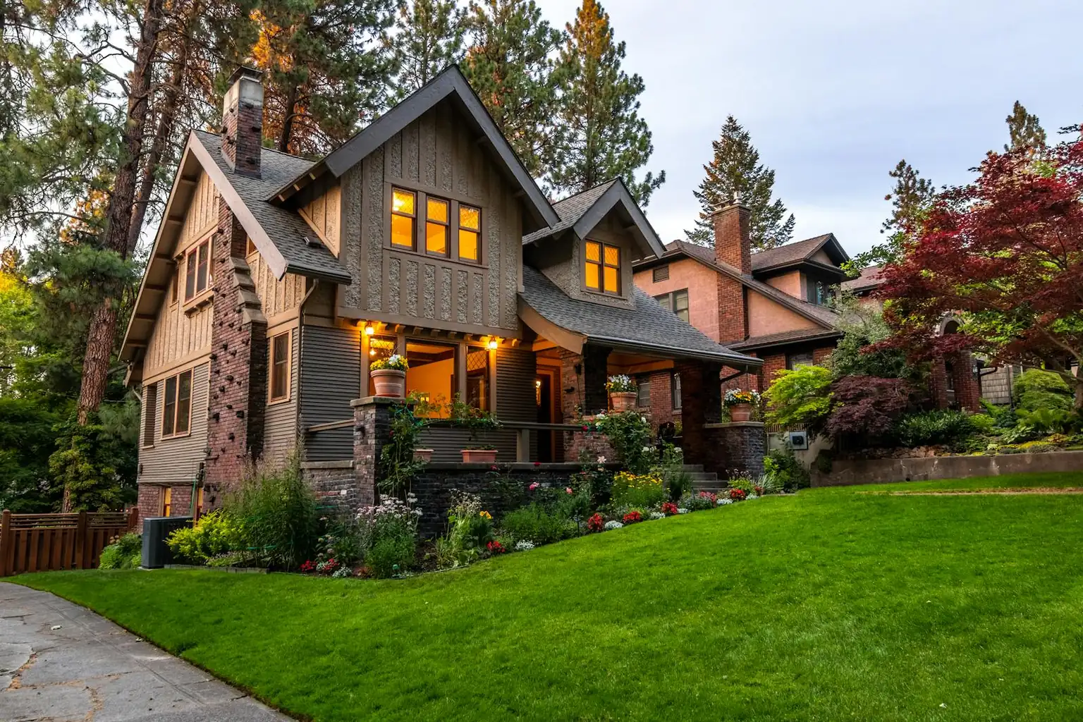 Lush, well-irrigated landscape with ornamental grasses and layered plantings at twilight